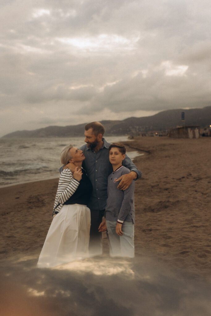 family with 10 years old son on the beach