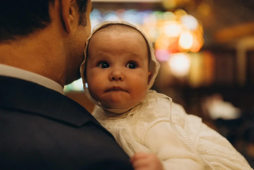 Baptism photographer Barcelona — baby in lace christening bonnet